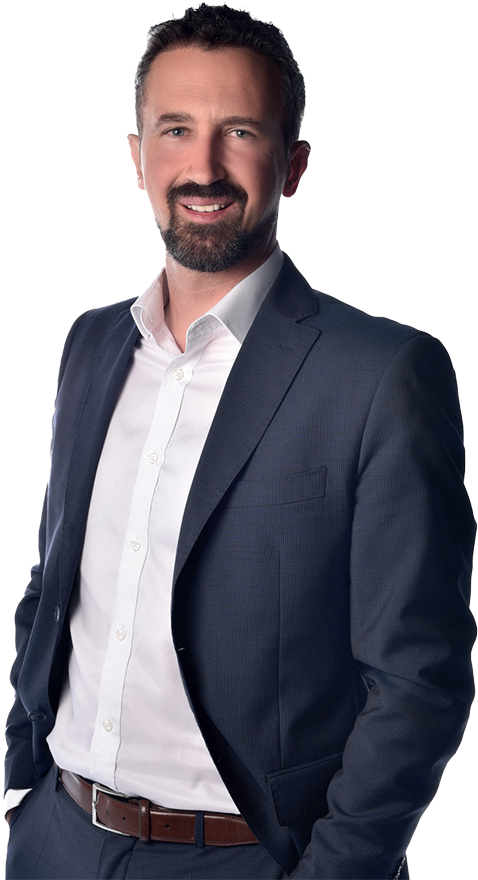 A man in a suit from a Marketing Agency in Geneva posing for a photo.