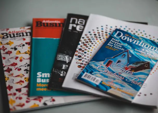 A collection of custom business magazines on a table.