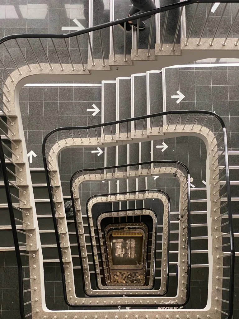 A person from an event management company is walking up a set of stairs.