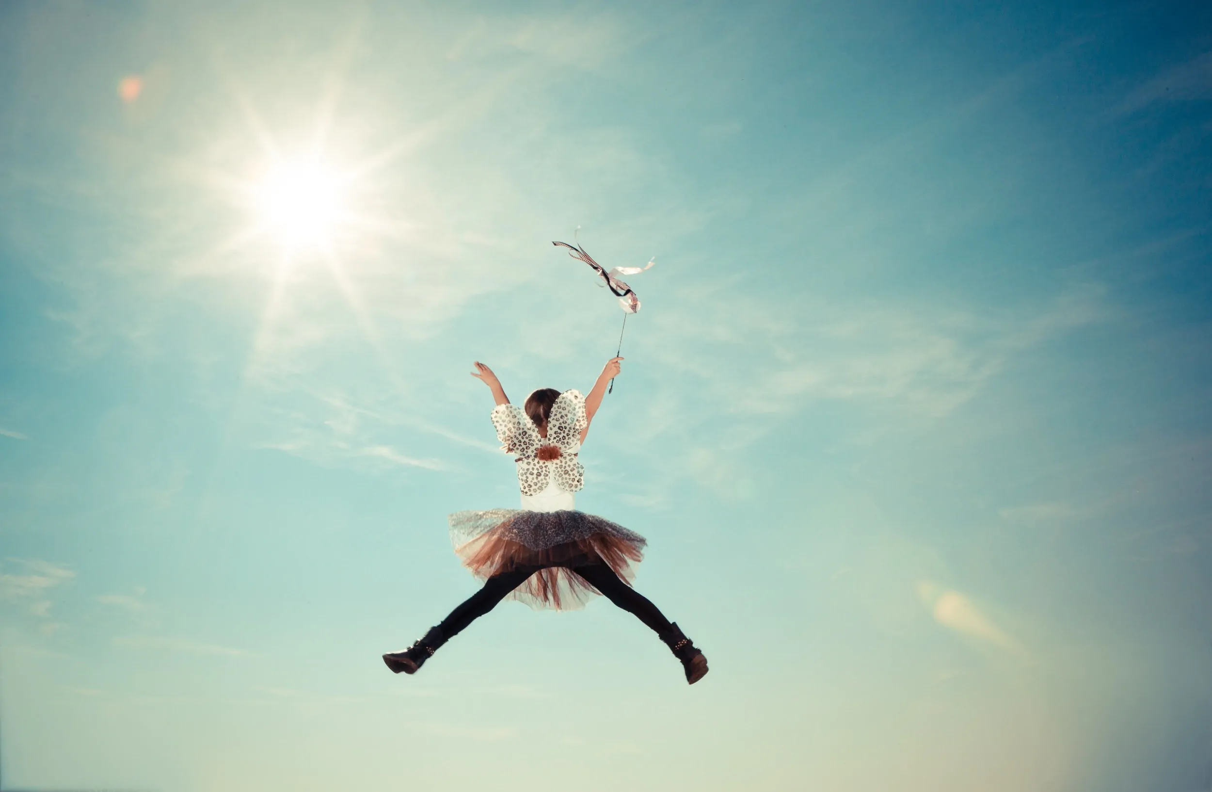 A girl jumping in the air with a kite for a marketing agency campaign.